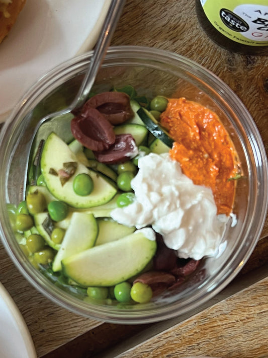 a summer dish of a bagel filled with a range of ingredients in a bowl